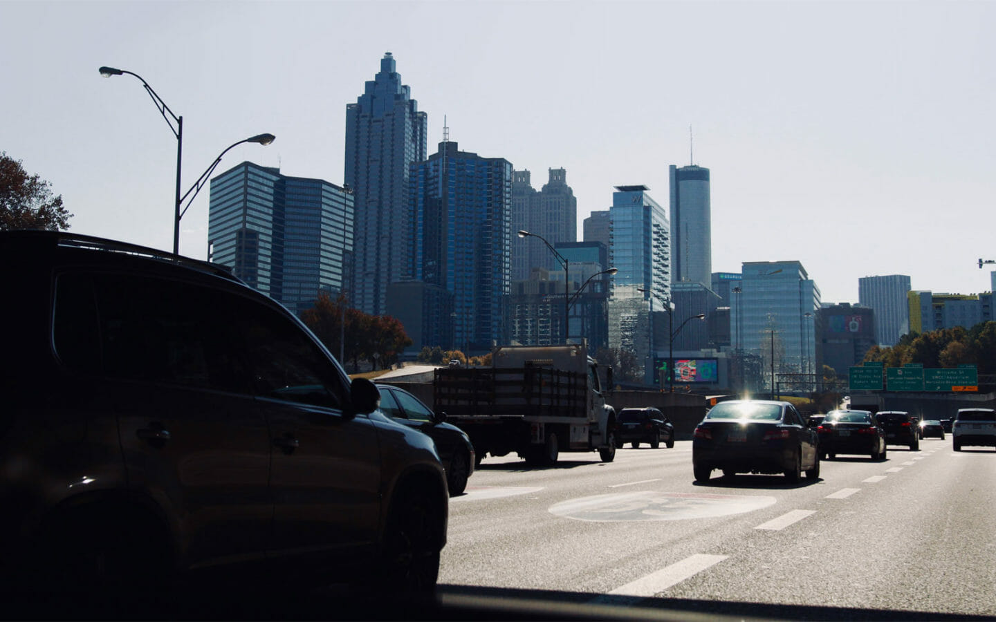cars on road near high rise buildings during daytime